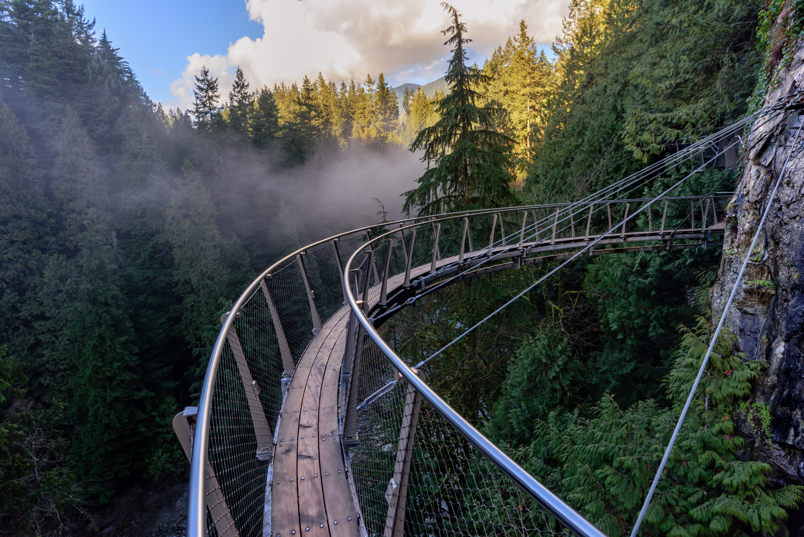 Curved Cliffwalk suspended above the rainforest at Capilano Suspension Bridge Park in North Vancouver.