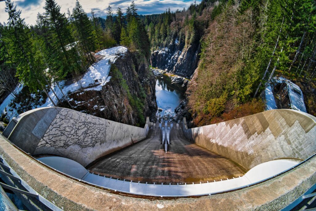 Panoramic view from Cleveland Dam overlooking the Capilano River canyon and surrounding forest in North Vancouver, Canada.