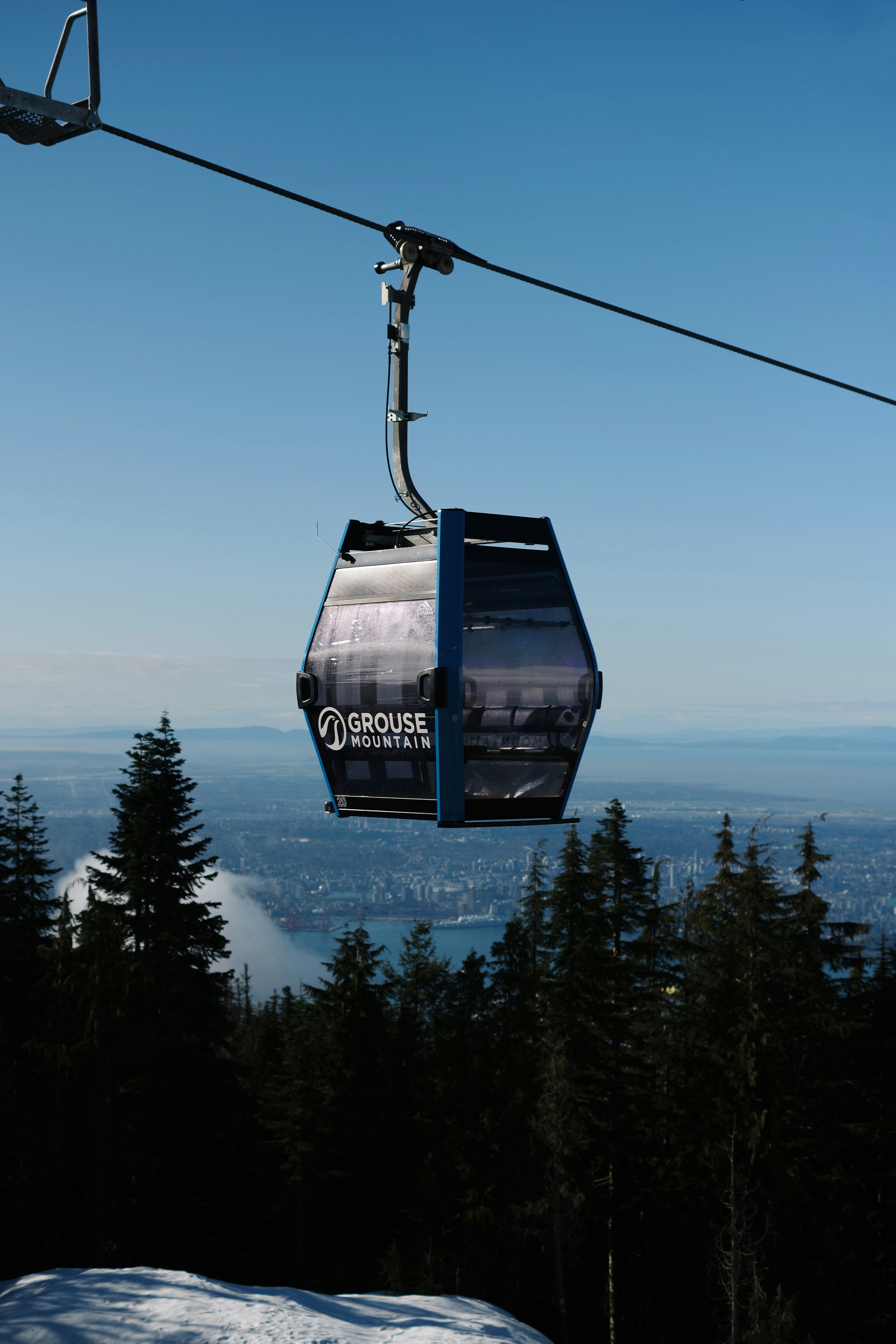 Grouse Mountain Skyride gondola overlooking Vancouver from the mountain summit.