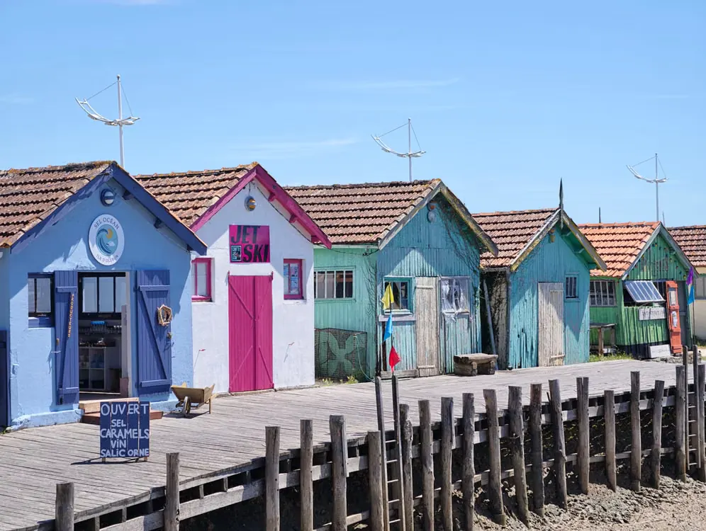 Colorful wooden oyster huts along the waterfront of Arcachon Bay in southwest France