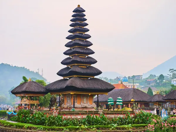 Traditional Balinese temple beside a lake surrounded by mountains