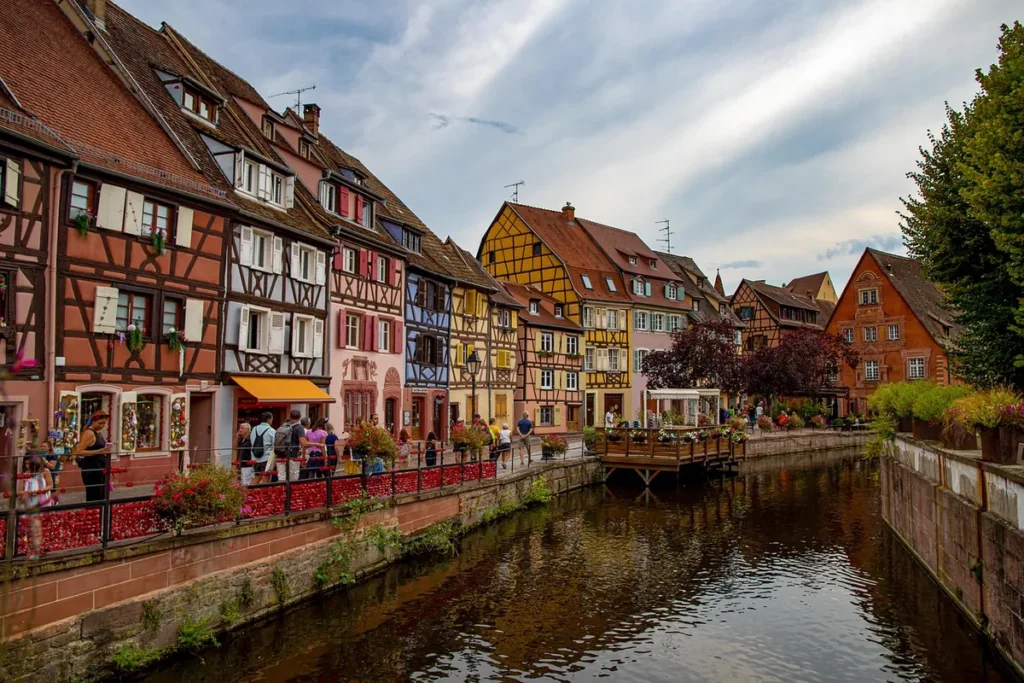 Colorful half-timbered houses lining a canal in the Little Venice district of Colmar, Alsace