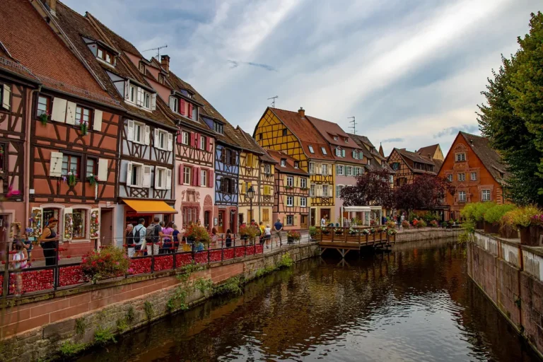 Colorful half-timbered houses lining a canal in the Little Venice district of Colmar, Alsace