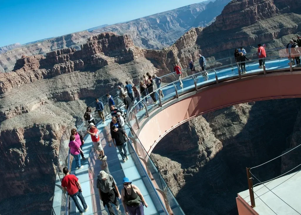 Tourists walking across the glass-bottomed Grand Canyon Skywalk suspended above the cliffs at Grand Canyon West