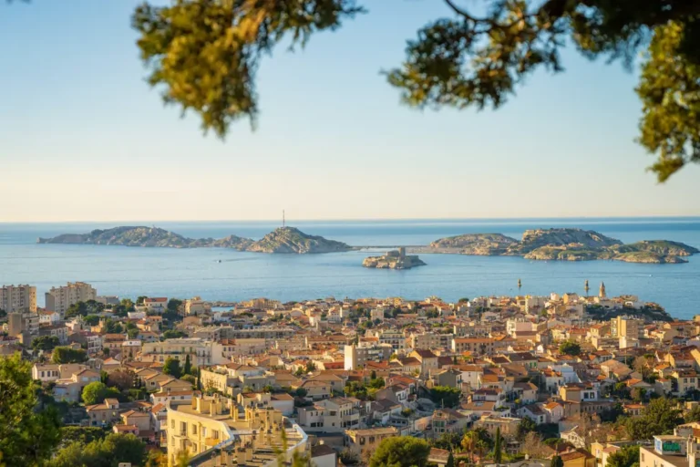 Panoramic view of Marseille rooftops and the Mediterranean Sea with the Frioul Islands in the distance