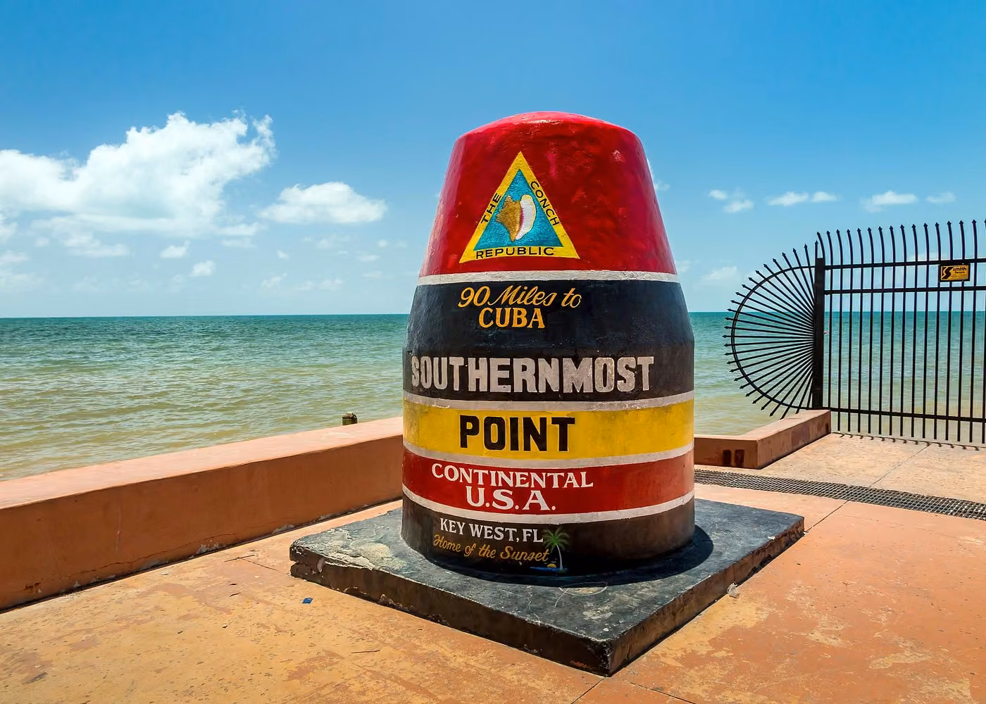 Colorful Southernmost Point buoy monument overlooking the ocean in Key West Florida