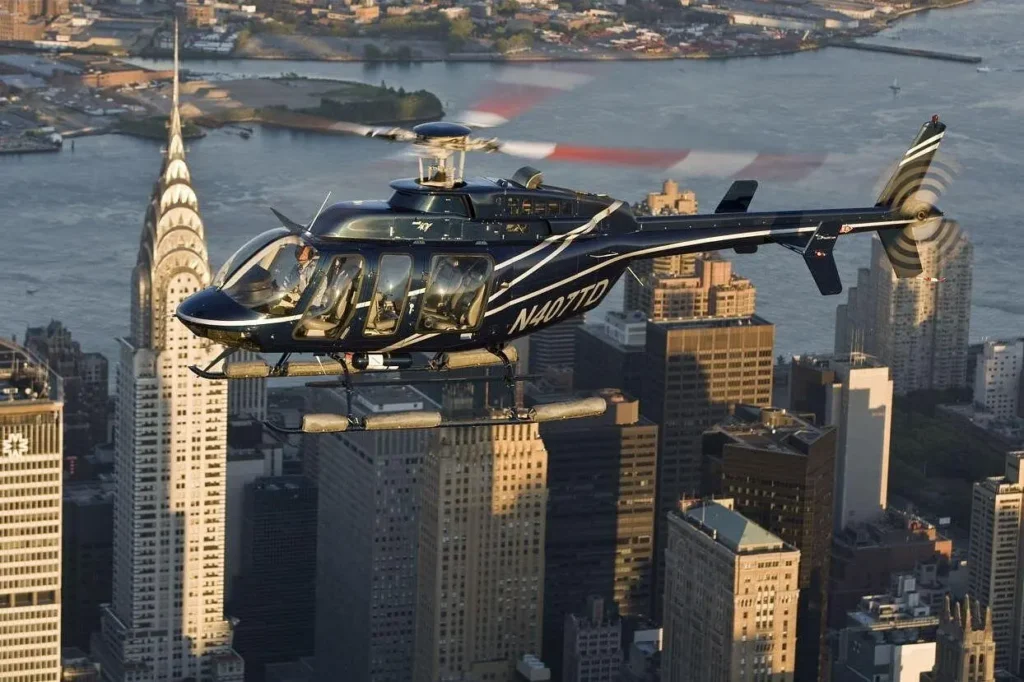 Black sightseeing helicopter flying over Manhattan with the Chrysler Building and East River in the background