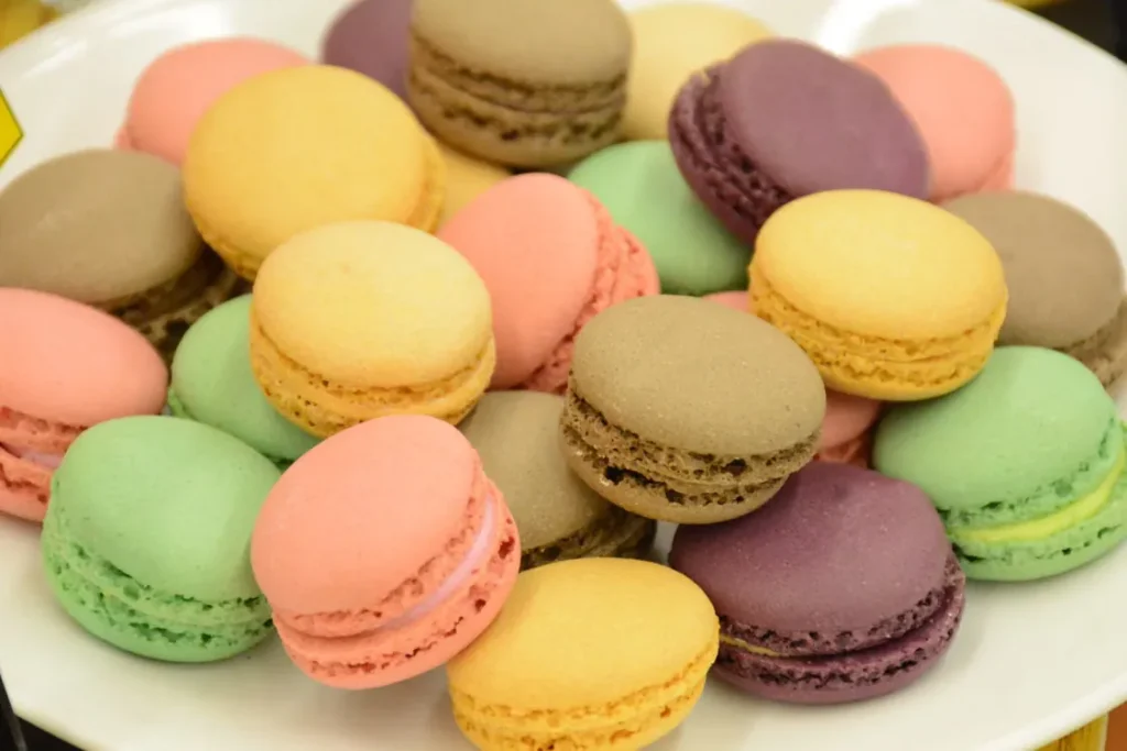 Close-up of colorful French macarons in pink, yellow, green, purple and chocolate tones