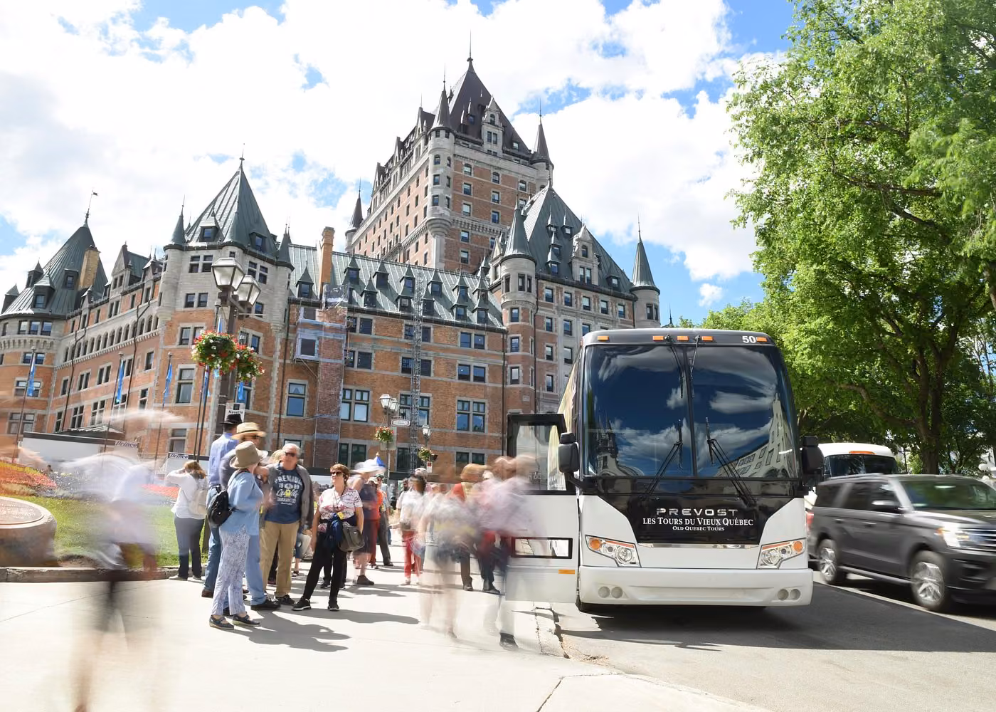 Tour bus and visitors in front of Château Frontenac in Old Quebec City