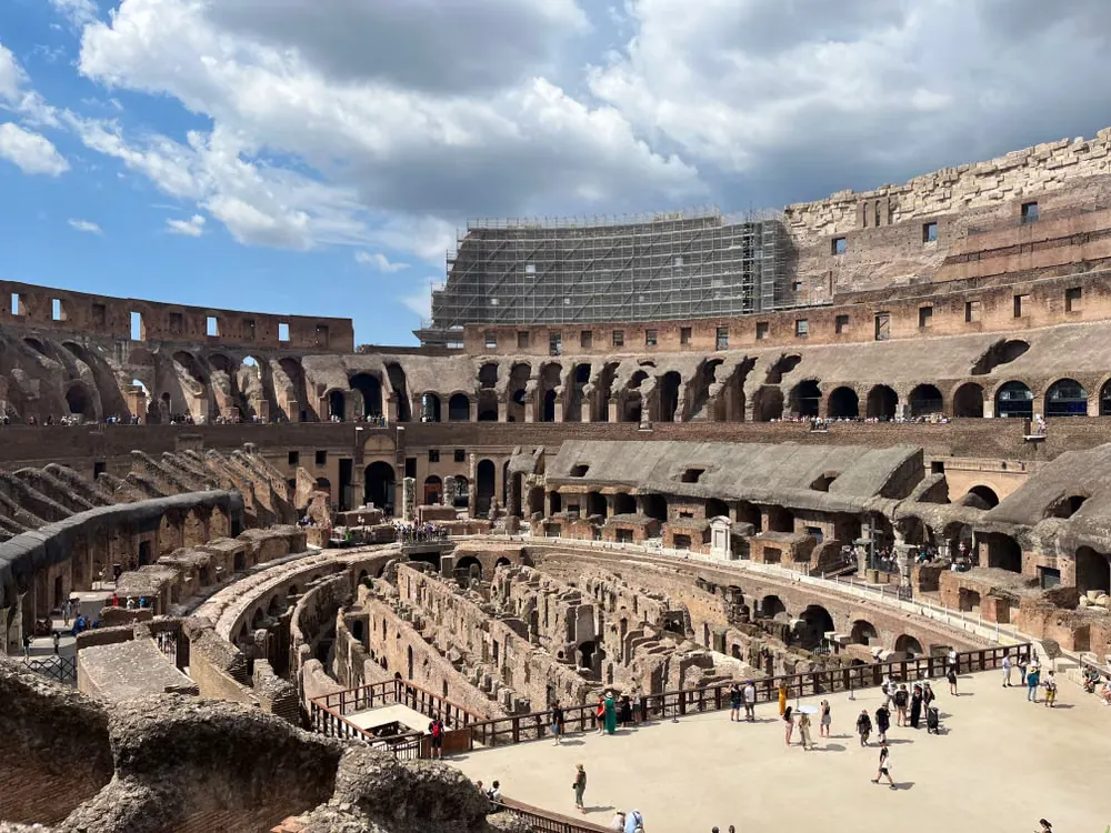 Interior view of the Colosseum in Rome showing the ancient underground ruins beneath the arena