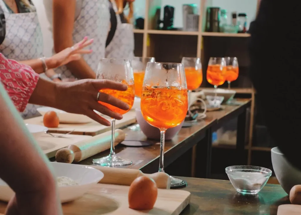 Orange spritz cocktails on a table during a hands-on Italian cooking and cocktail class