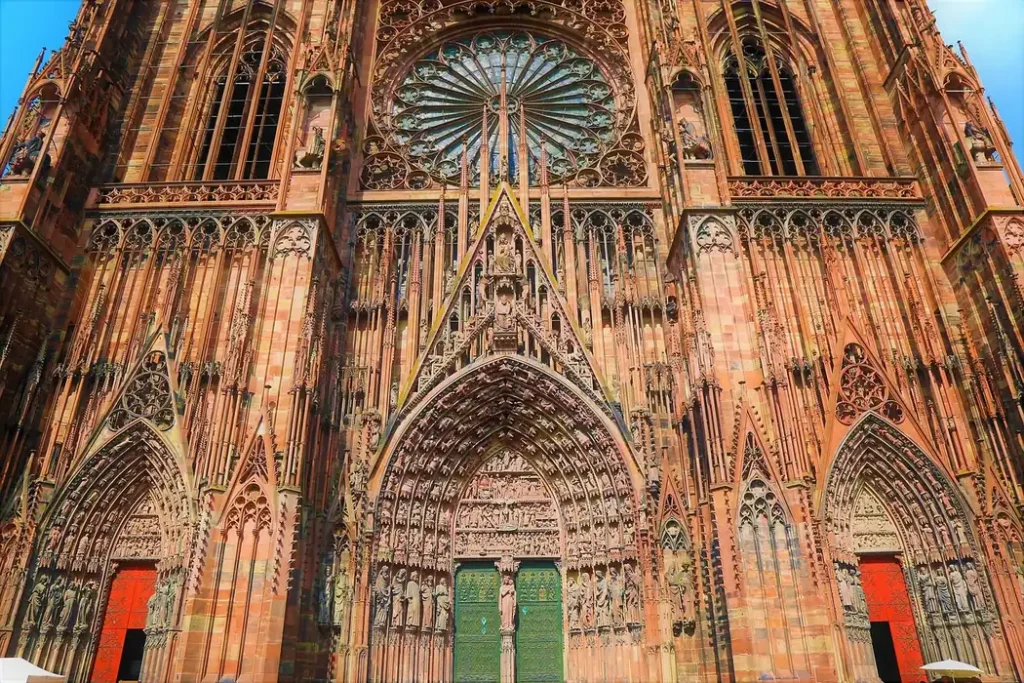Close-up of Strasbourg Cathedral's Gothic sandstone facade with its ornate rose window, sculptures and entrance portals