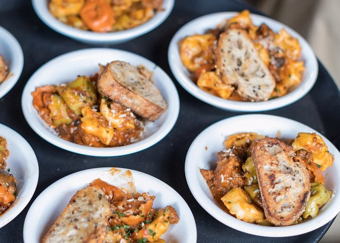 Small plates of pasta and toasted bread served during a Vancouver Gastown food tasting experience